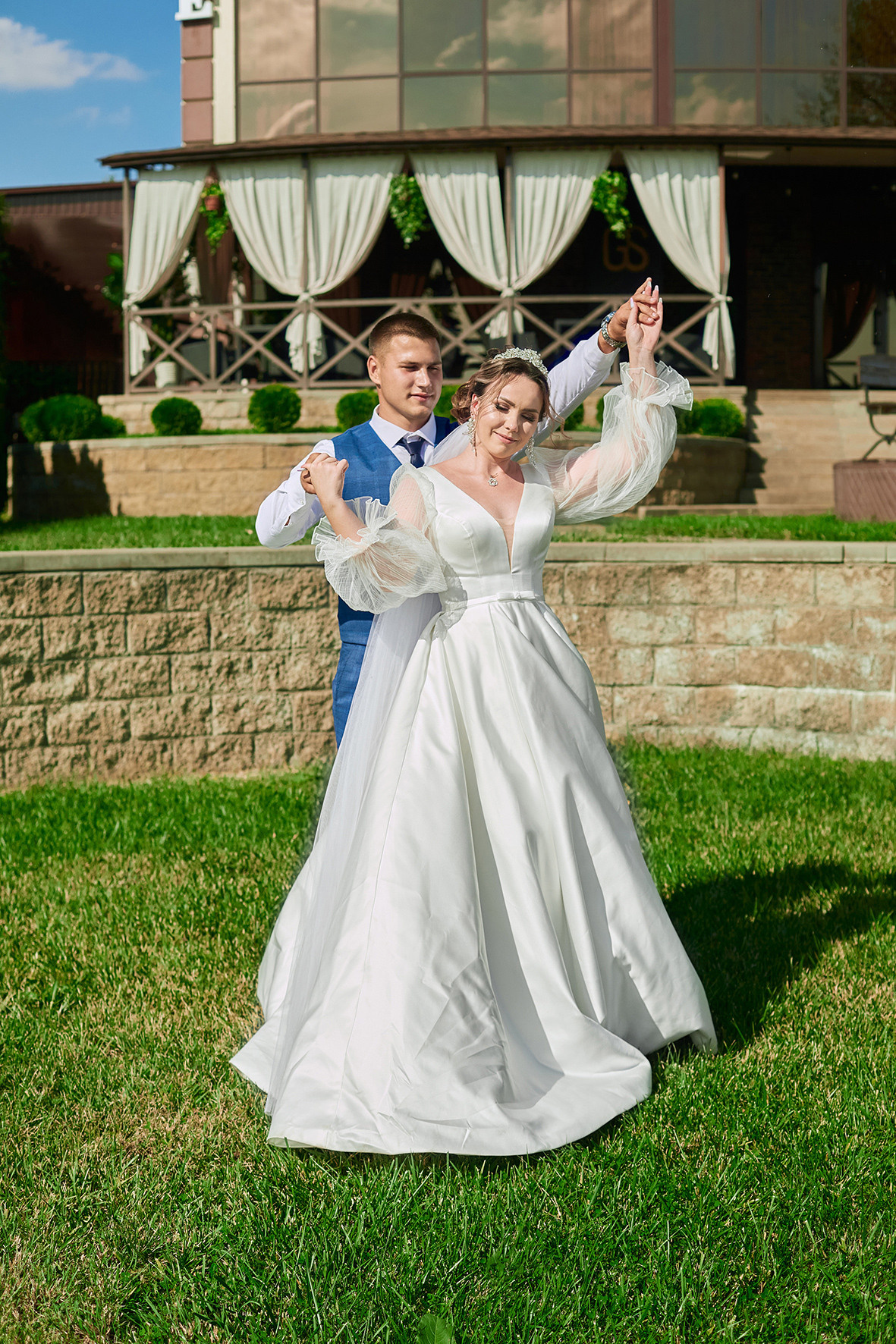 Жених и невеста танцуют на лужайке перед летним кафе. Фотограф. Тимашевск. Кубань. Краснодарский край.