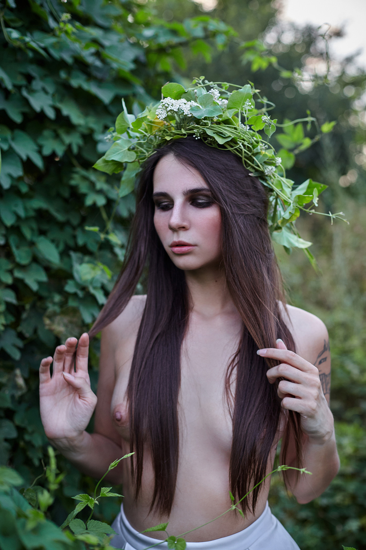 Художественный портрет девушки в образе нимфы в блинной белой юбке с обнаженным торсом, длинными волосами и пышным венком из зелени. Фотограф. Тимашевск. Кубань. Краснодарский край.