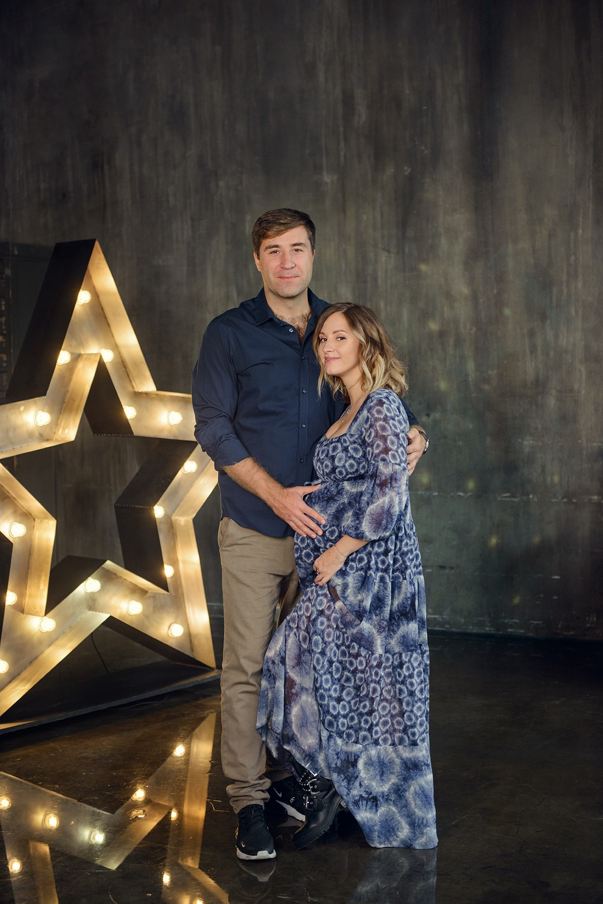 Family photo shoot with a pregnant woman in a loft studio, 