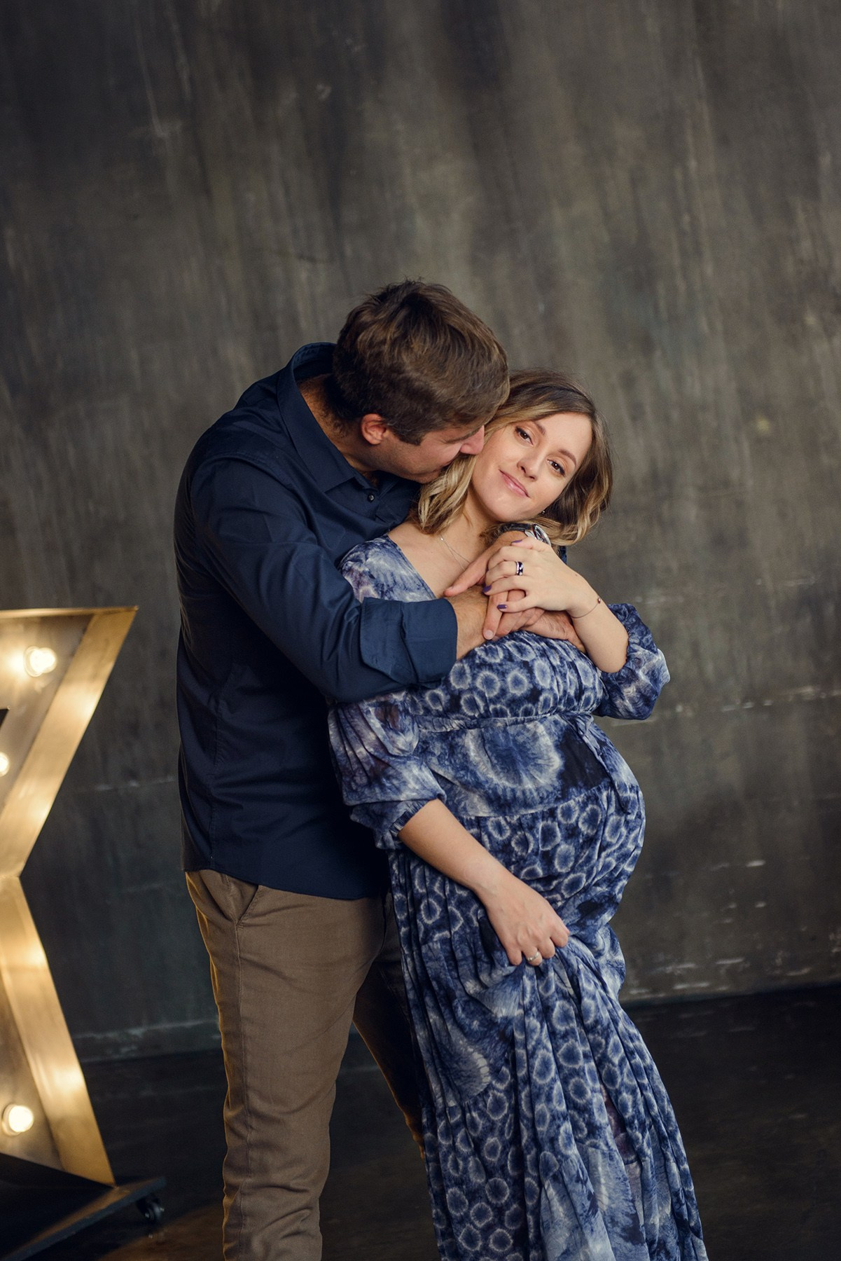 Family photo shoot with a pregnant woman in a loft studio, 