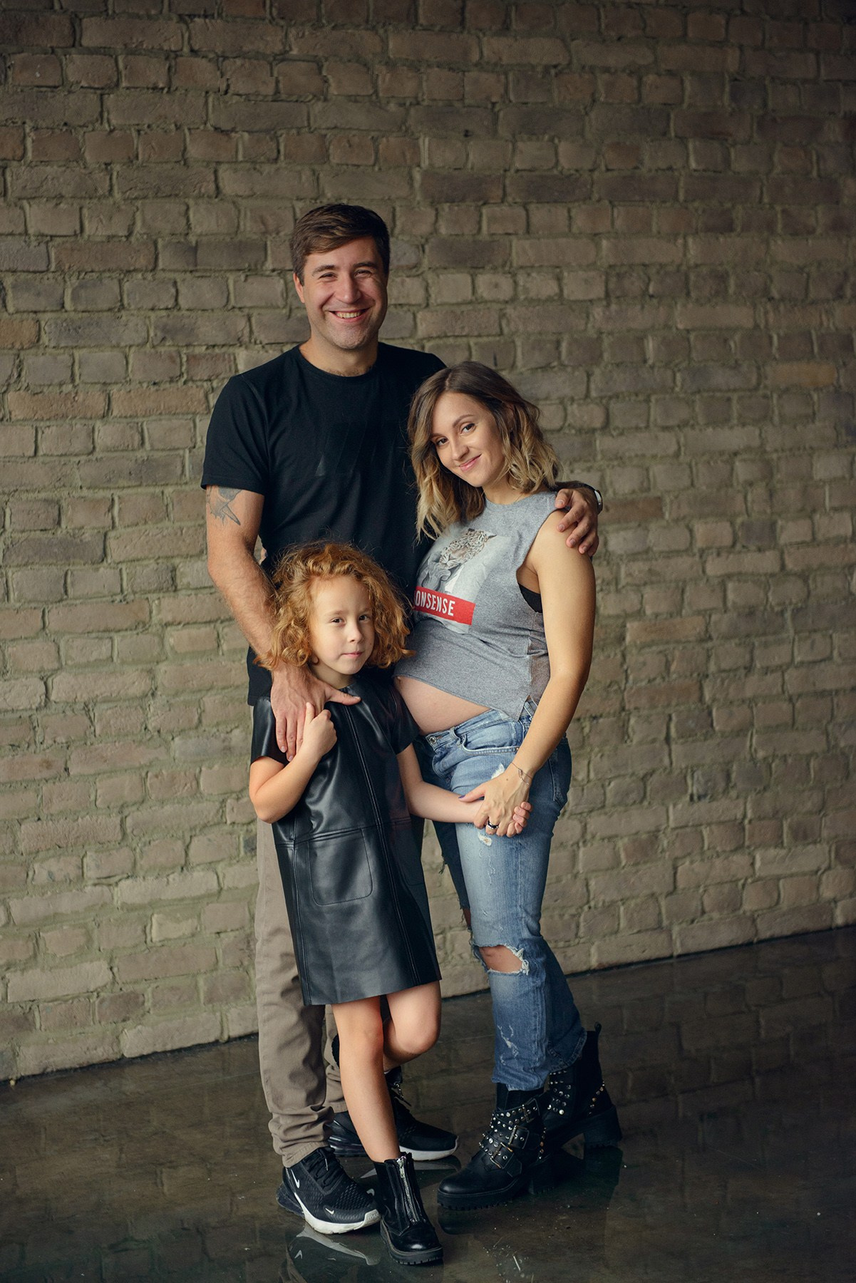 dad and daughter in a dark photo studio