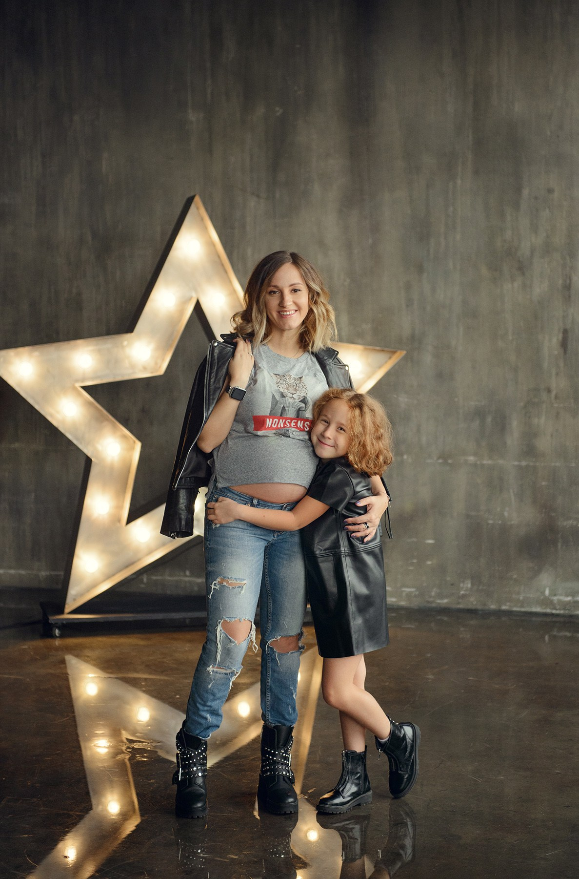 Family photo shoot with a pregnant woman in a loft studio, rock and roll style