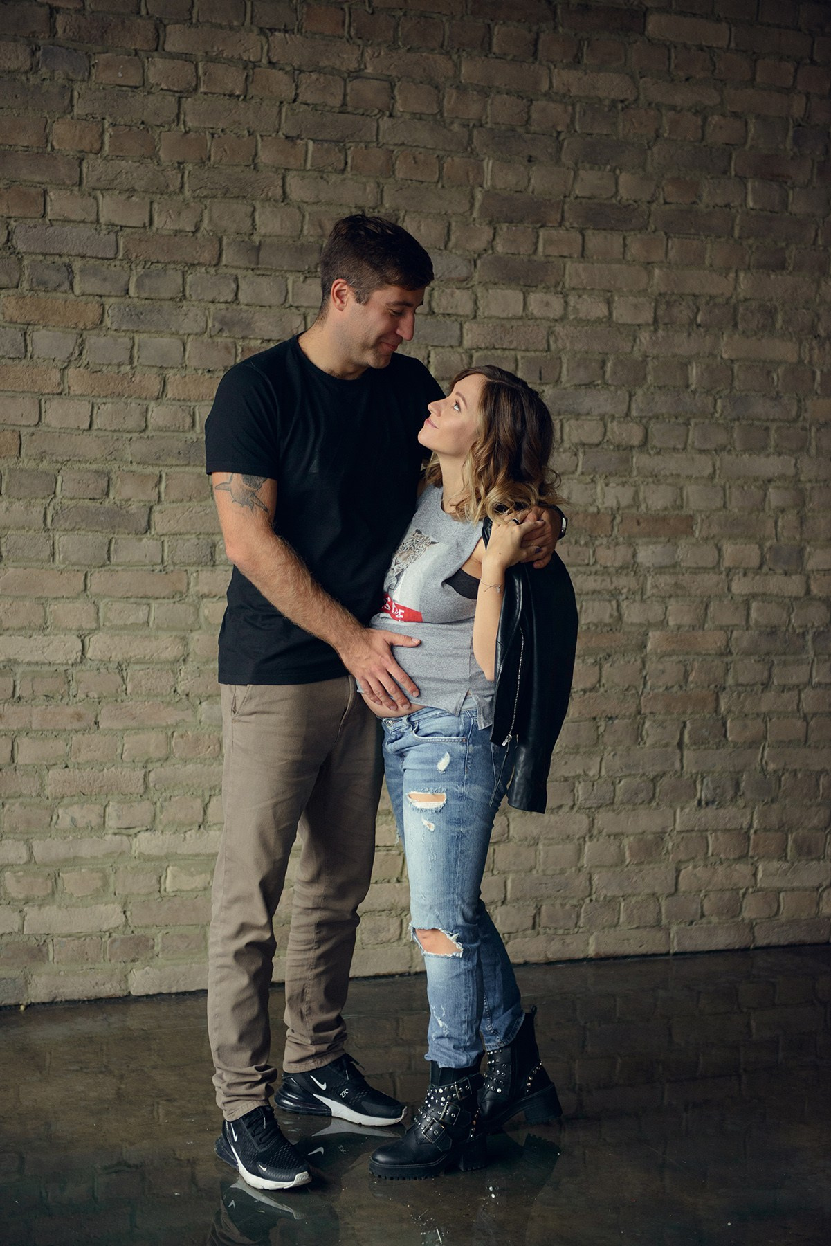 dad and daughter in a dark photo studio