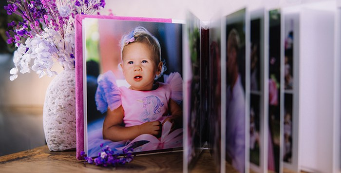 Разворот детской фотокниги с портретом ребенка и плотными страницами — премиальная печать.