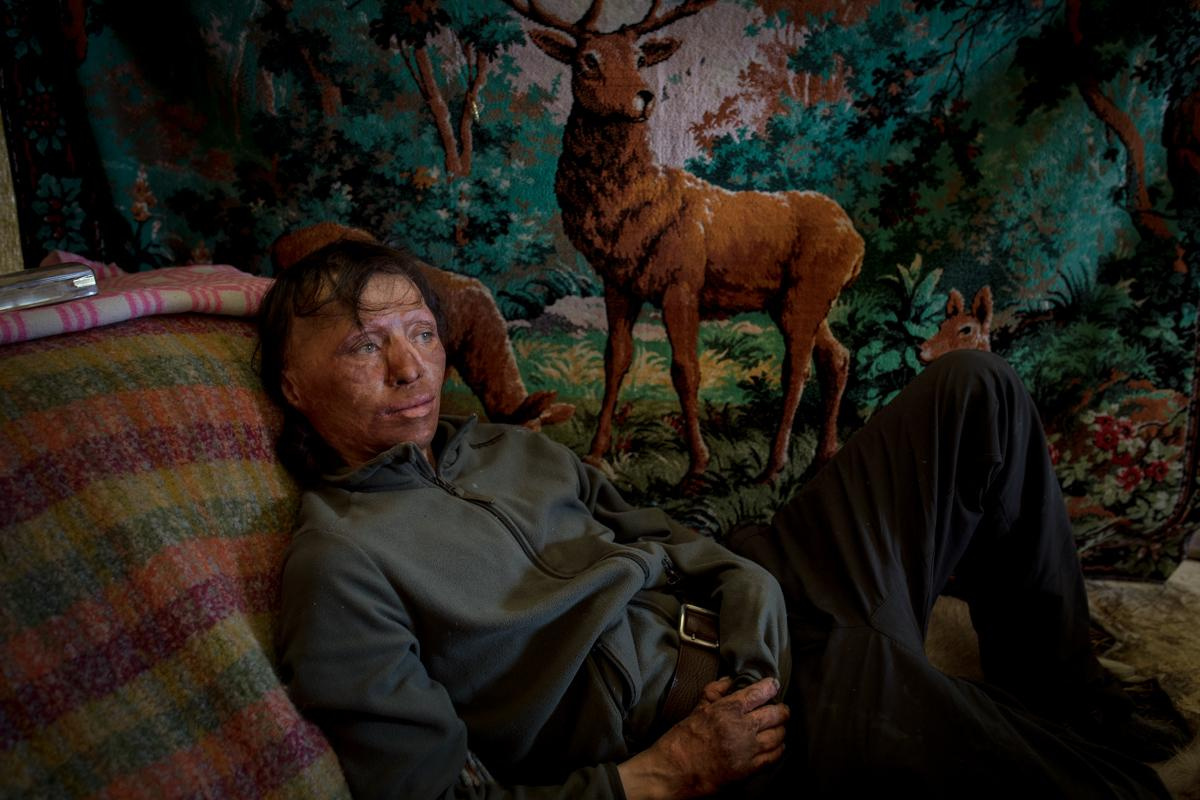 Reindeer breeder Grigory Baishev is resting in a tent after lunch.
