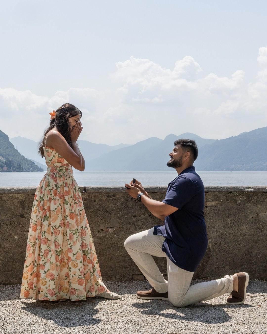 Proposal moment, couple holding hands by the lake