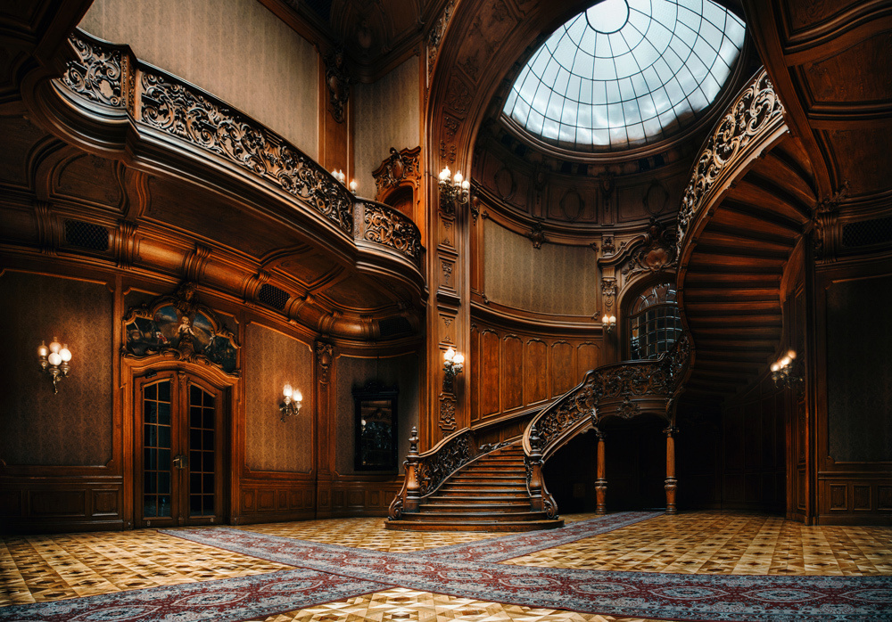 Lviv, Ukraine. The House of Scientists. The interior of the magnificent mansion with the ornate grand wooden staircase in the great hall. A former national casino.