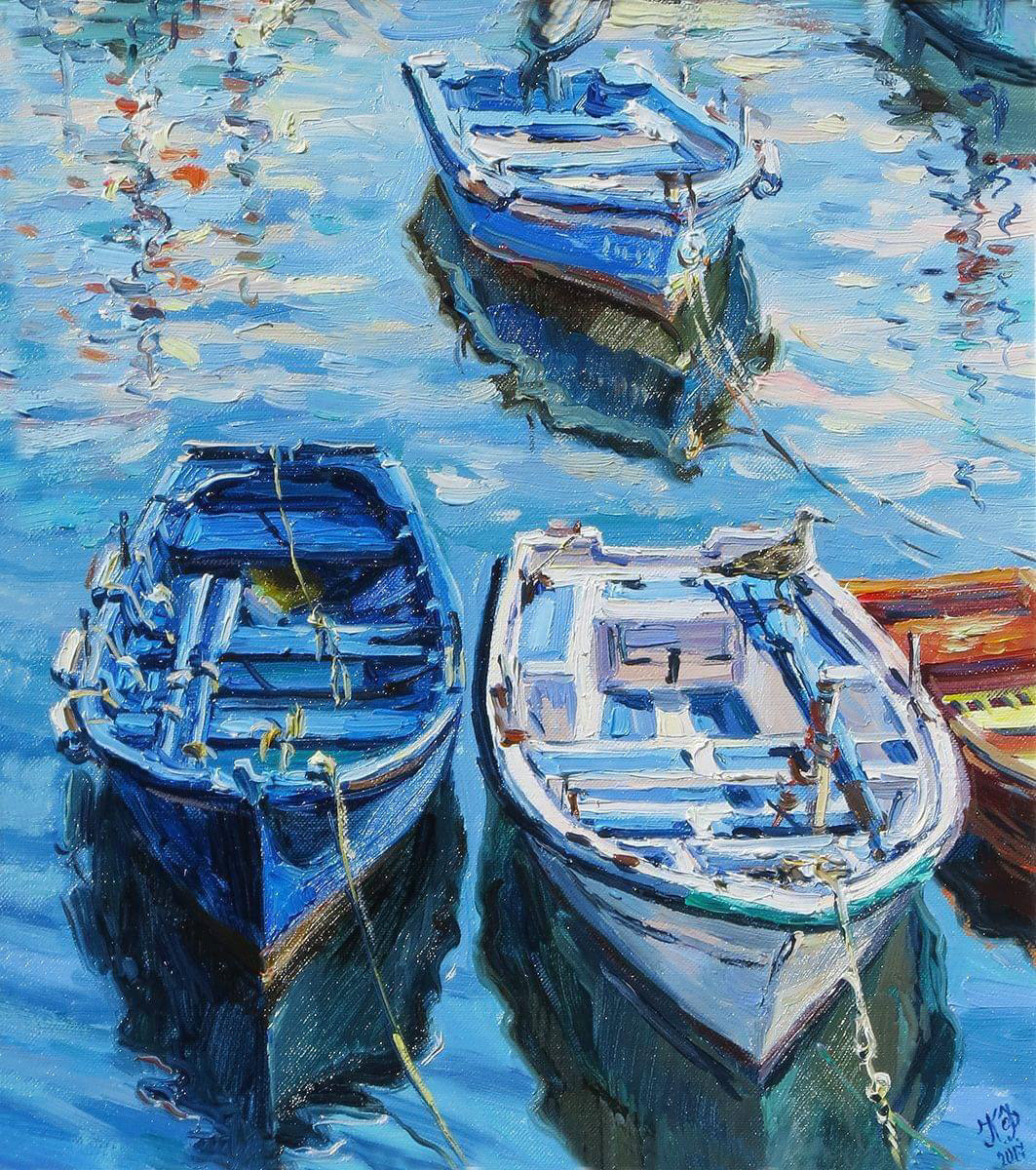Three boats in different shades of blue