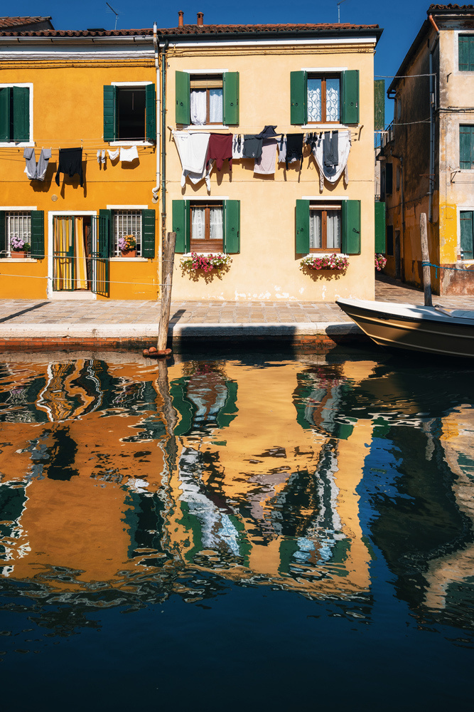 Burano island, Venice, Italy. The Colorful houses with the reflection in a canal.