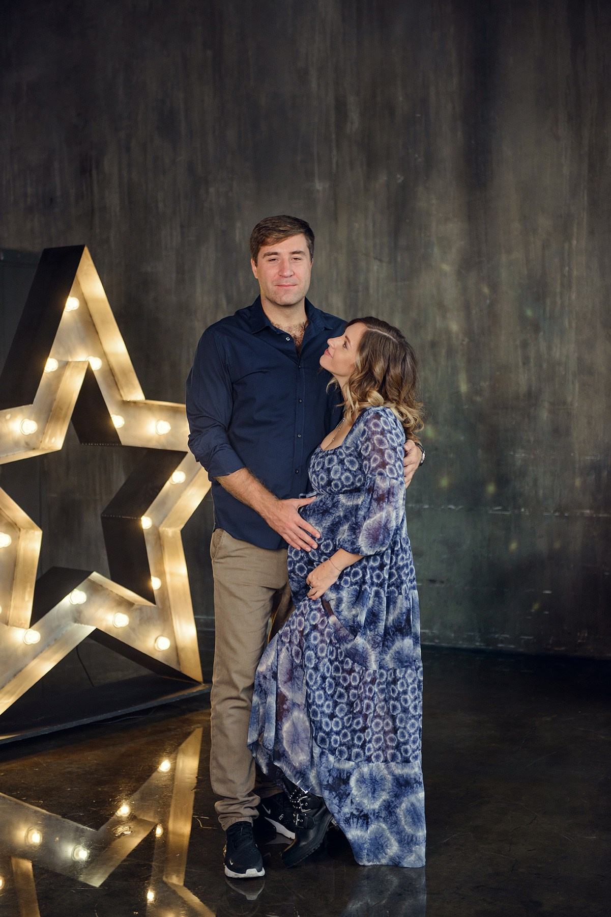 Family photo shoot with a pregnant woman in a loft studio, 
