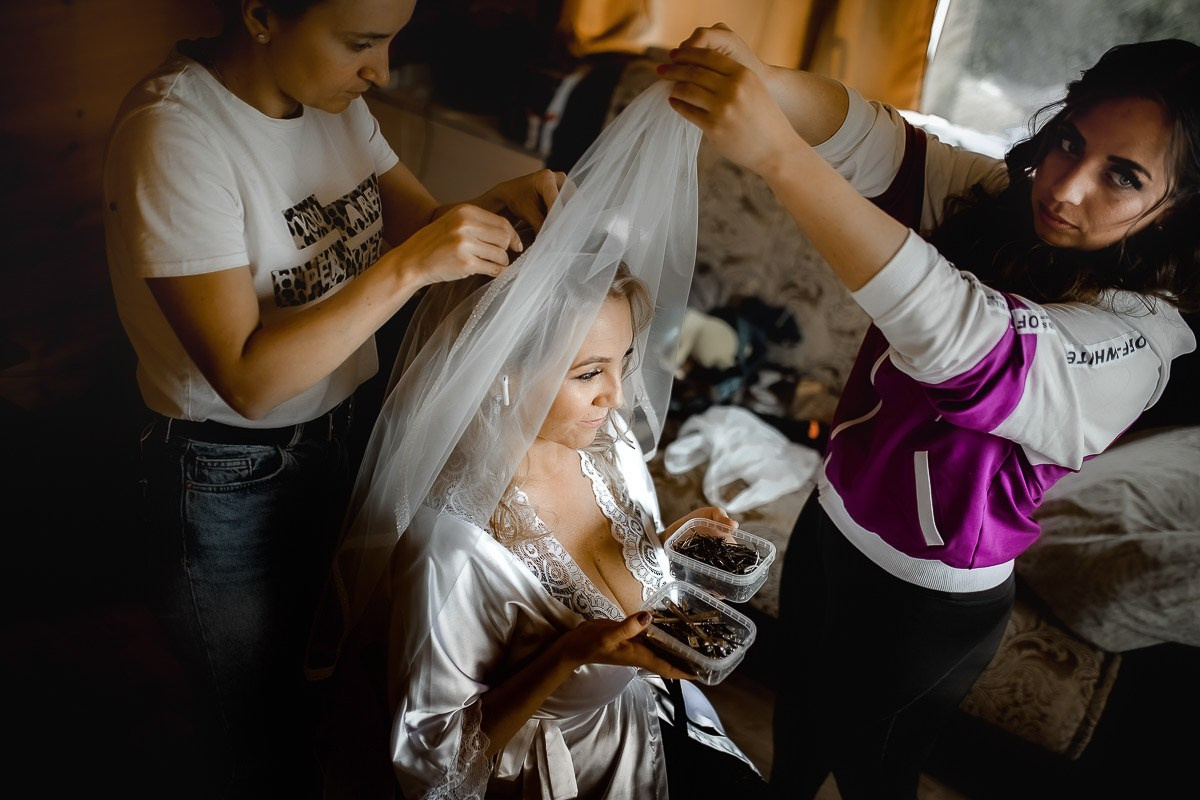 Сборы невесты. Невеста сидит в кресле. Невесте надевают фату в комнате в Санкт-Петербурге. Вид сверху