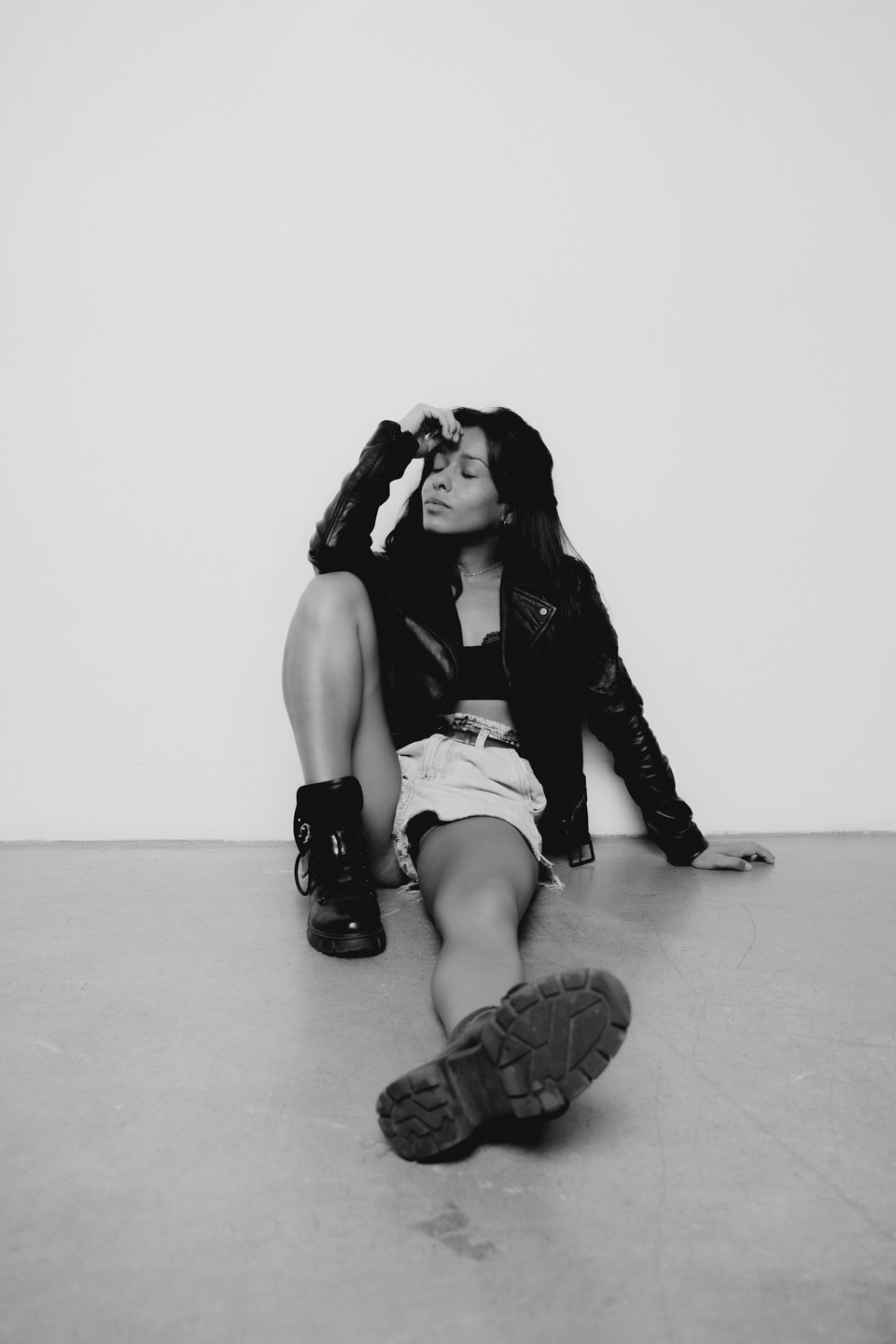 Кадр девушки на полу на фоне белой стены 