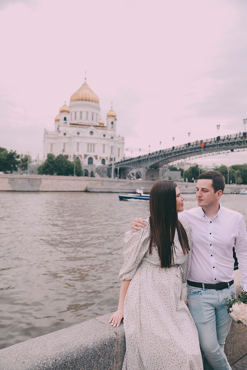 красивая молодая пара гуляет по набережной Москвы летом