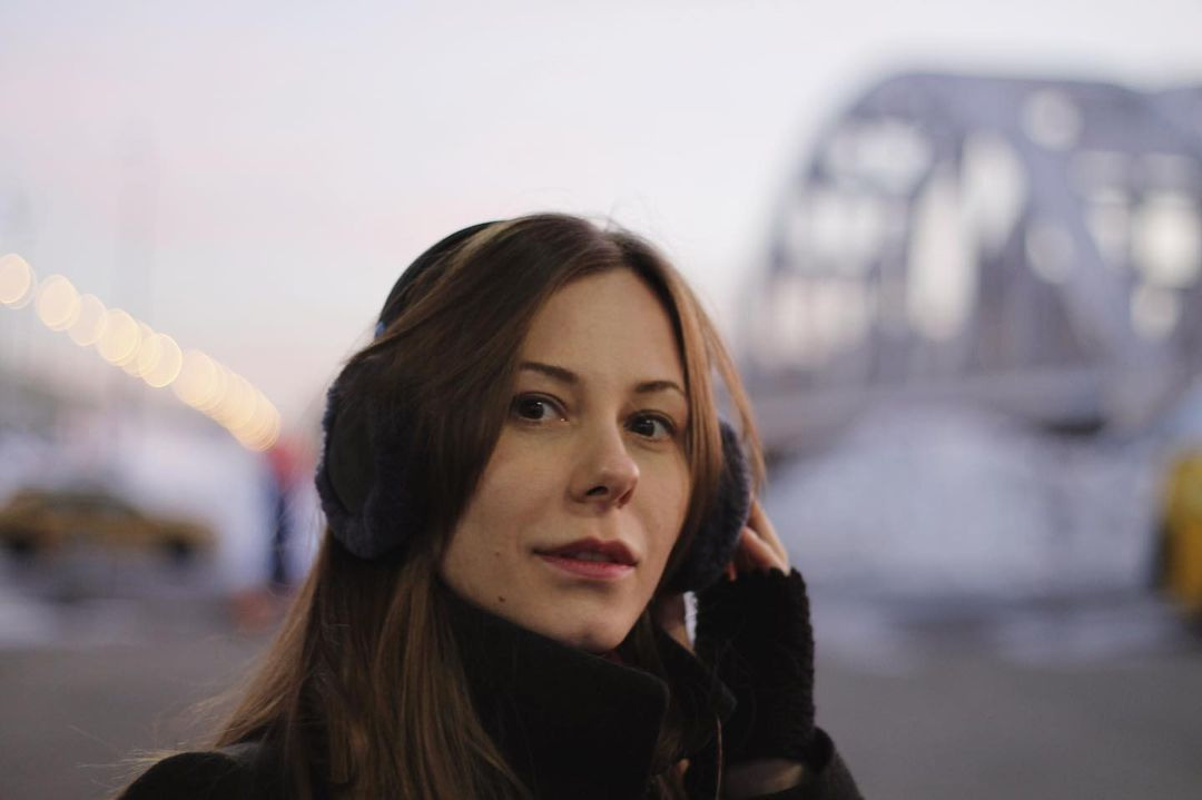 Woman in winter stays on the train station