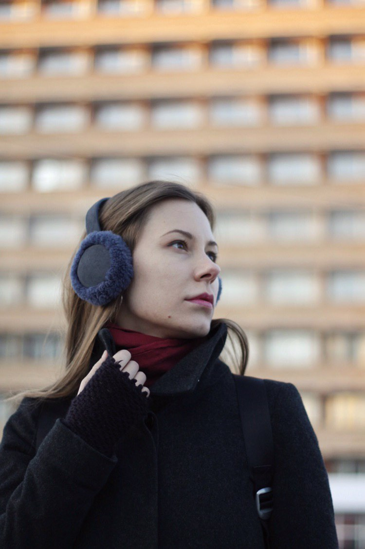 Woman in winter with soviet building on the background