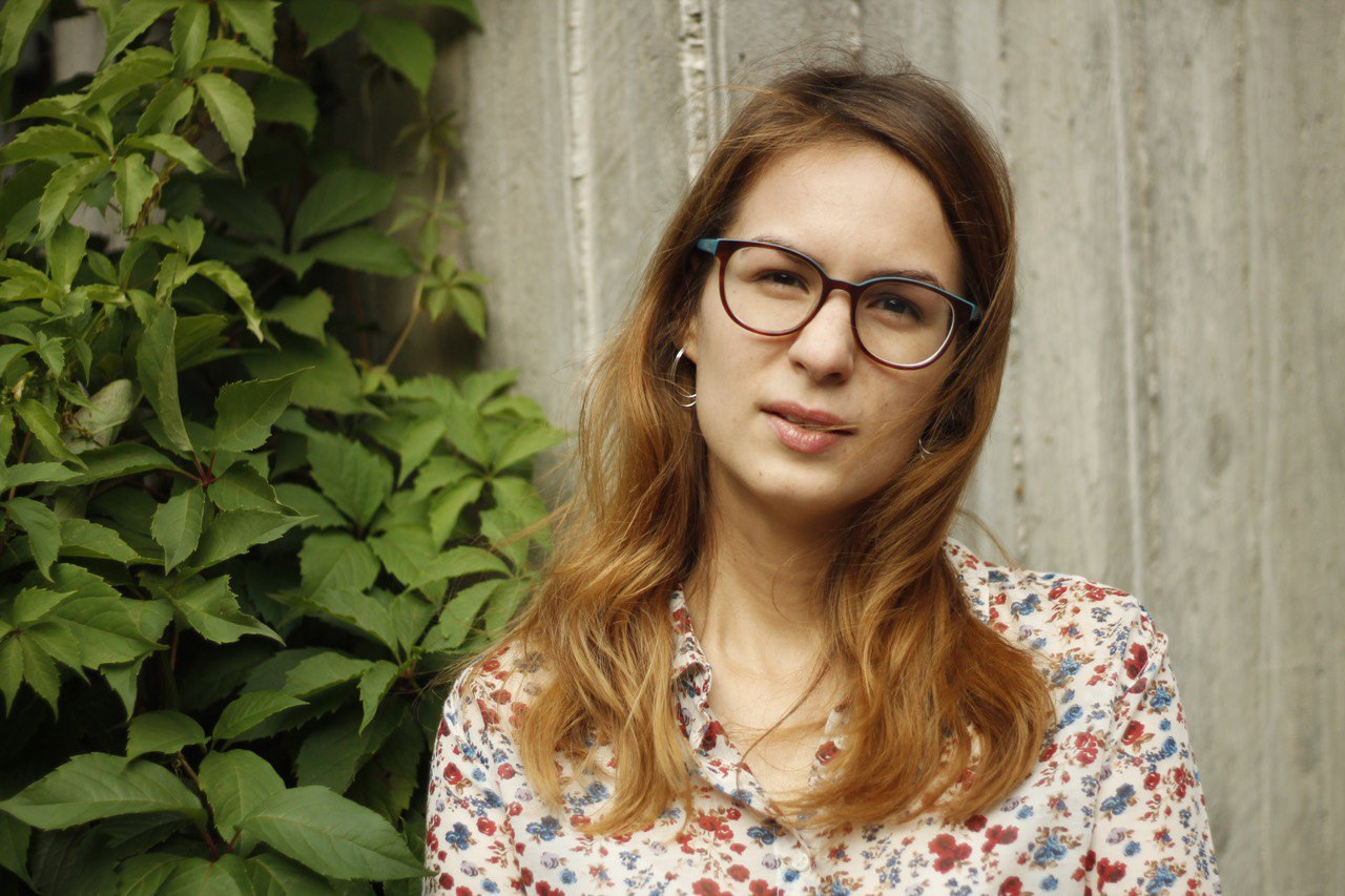 Portrait of woman with grey wall and green grape background