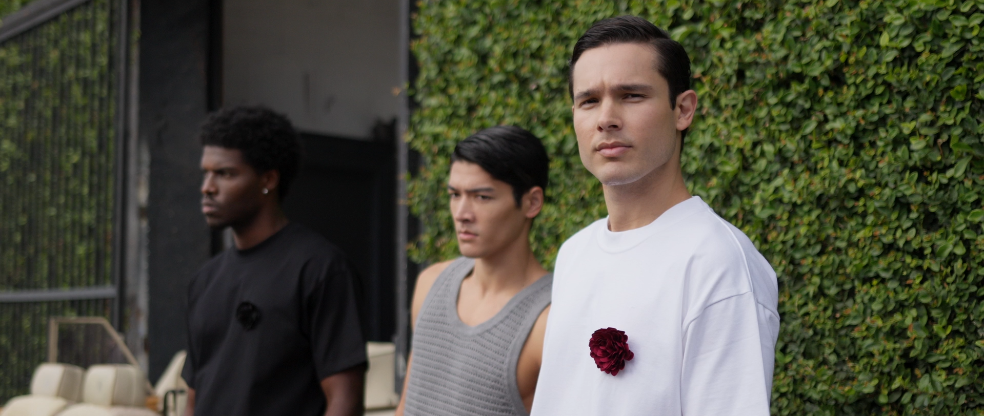 Outdoor portrait of models styled to represent modern brand identity, set against a lush green backdrop.