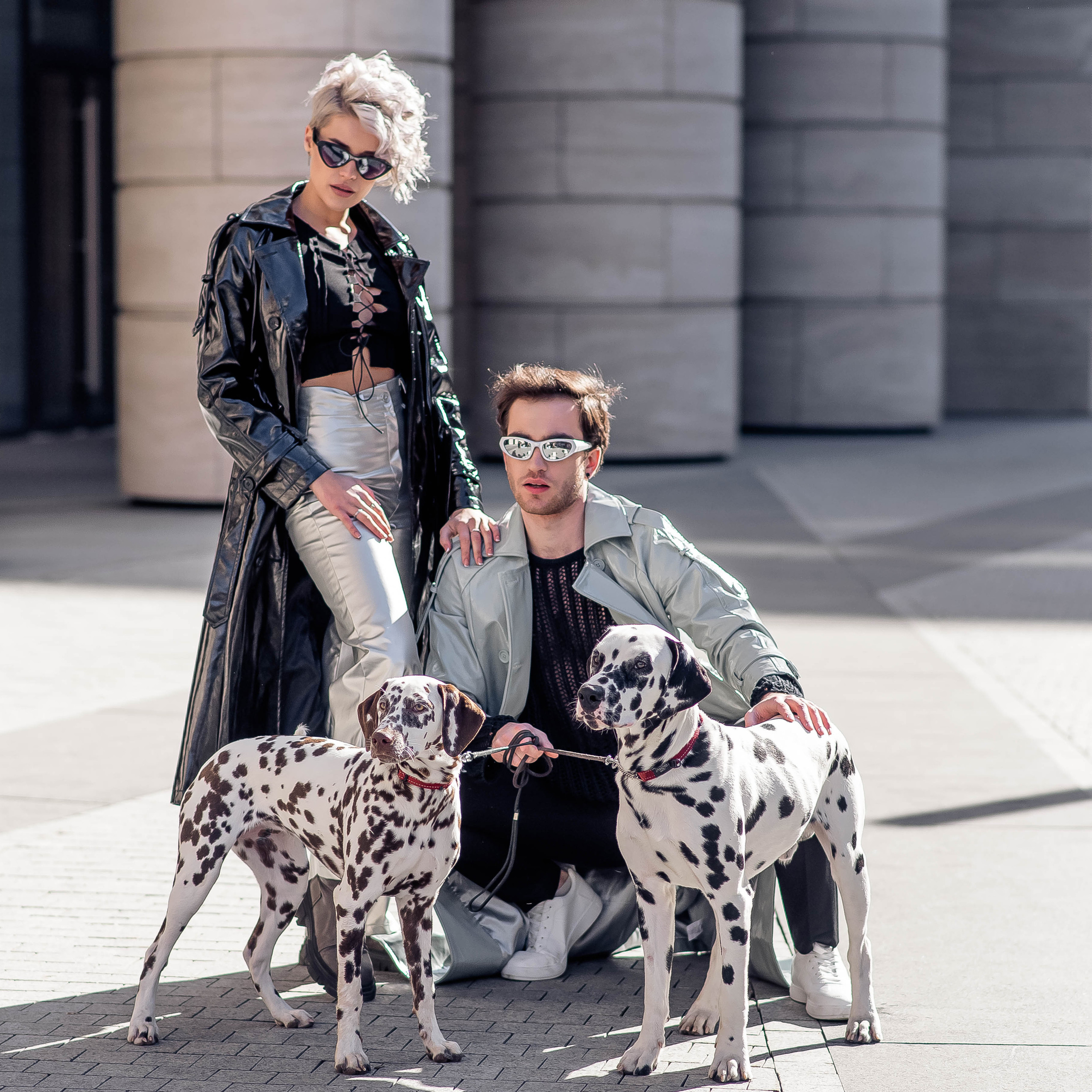 влюблённая пара гуляет с далматинцами