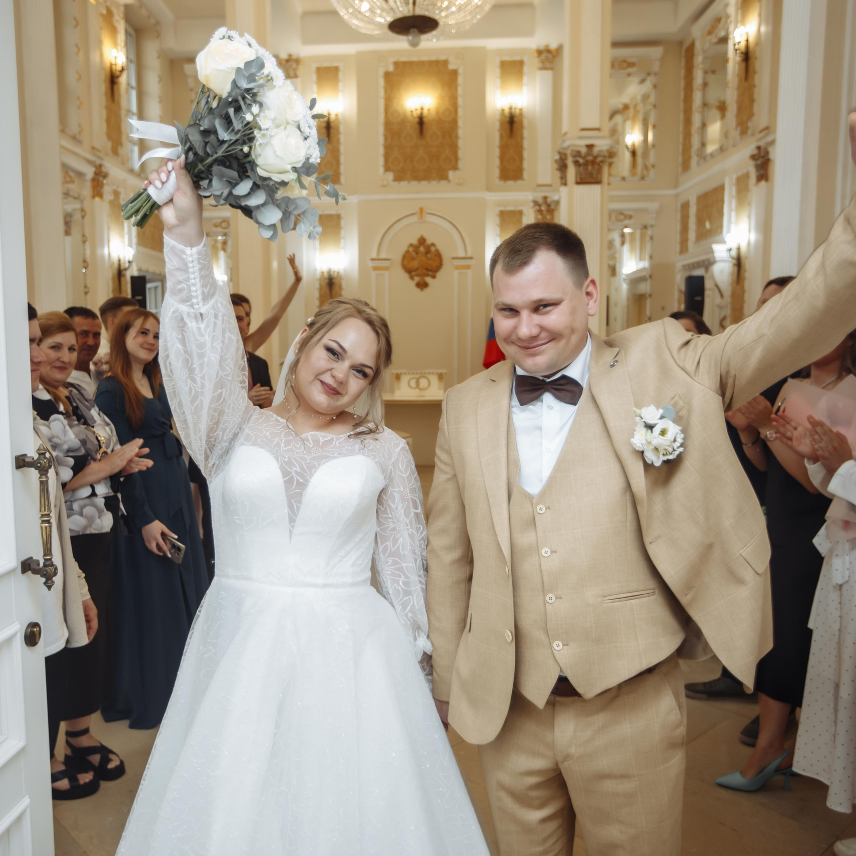 Радостные молодожёны выходят из ЗАГСа после регистрации брака