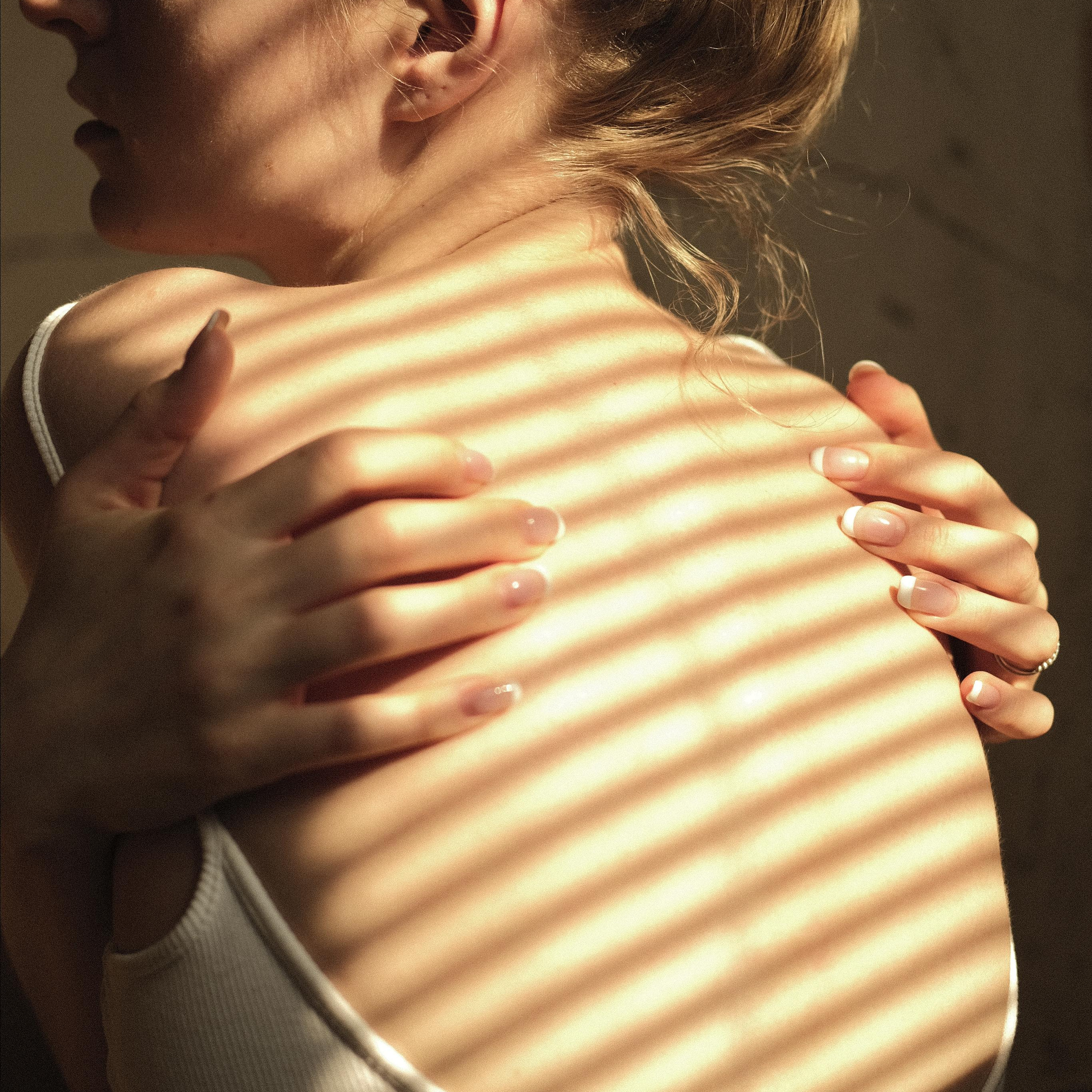 девушка обнимает себя руками