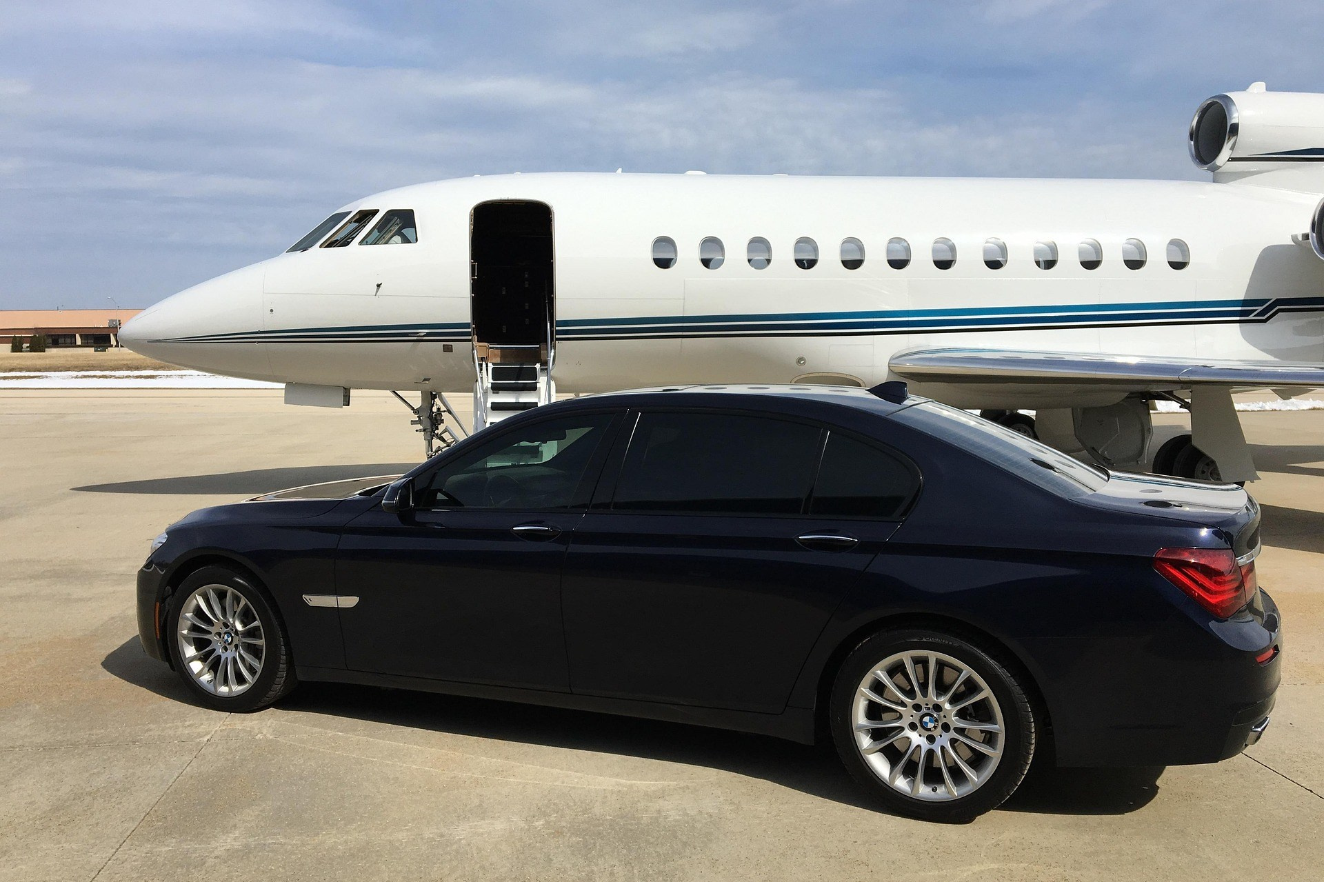Private jet and luxury car on the tarmac for VIP charter