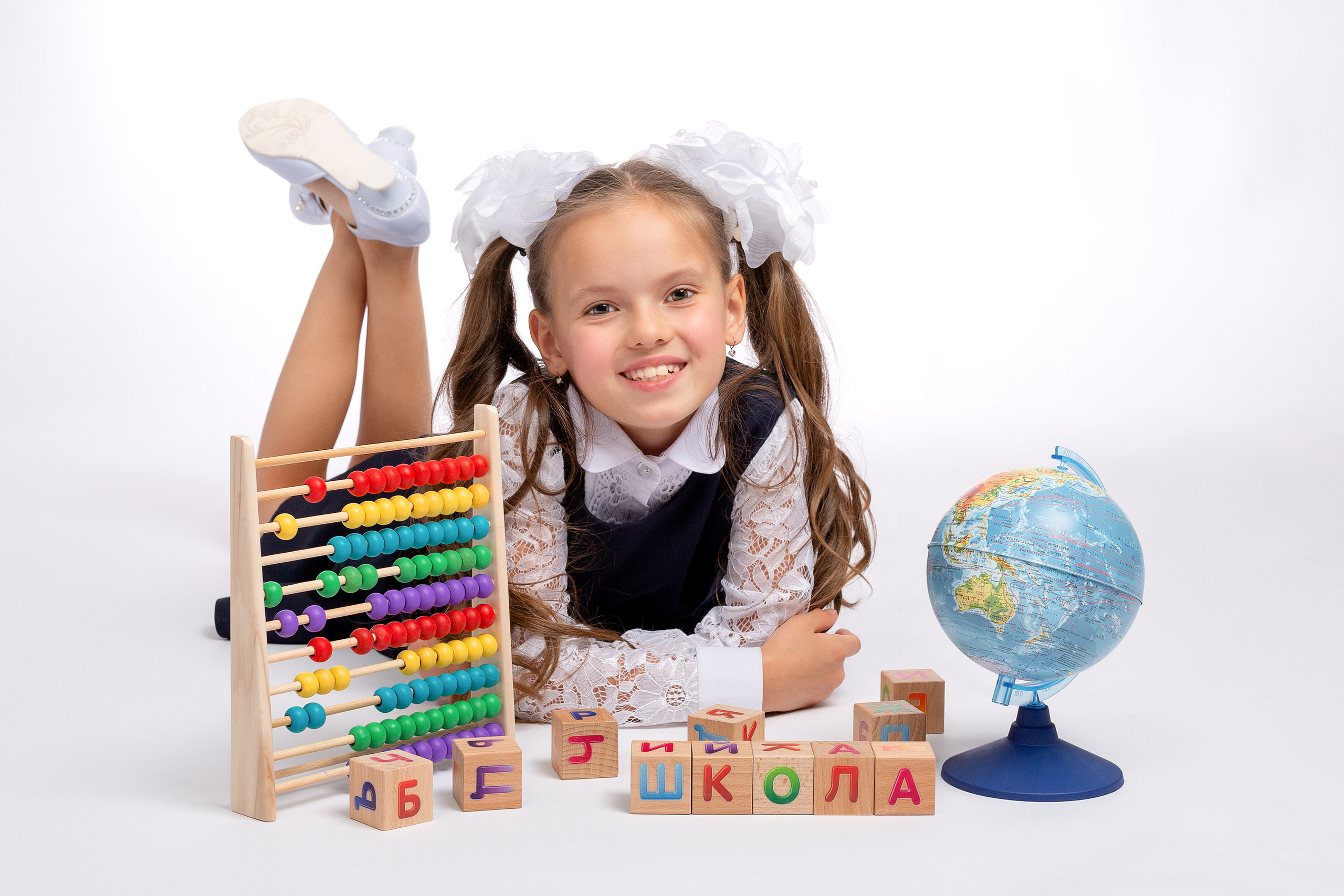 Кубики, глобус, счёты и первоклашка в фотостудии.