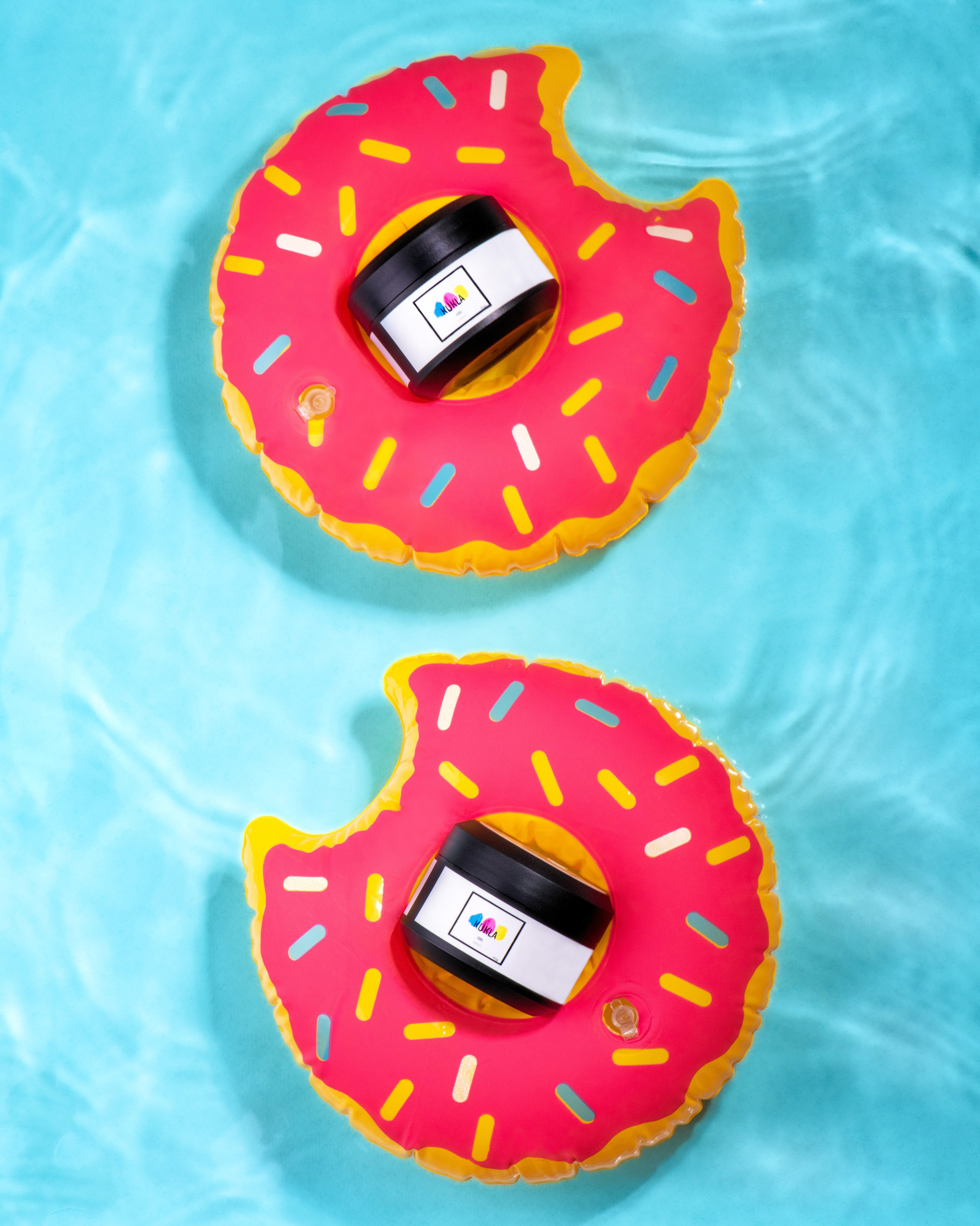 Имиджевая предметная фотография для бренда Kukla, гель-лак в баночках плавает в бассейне на кругах