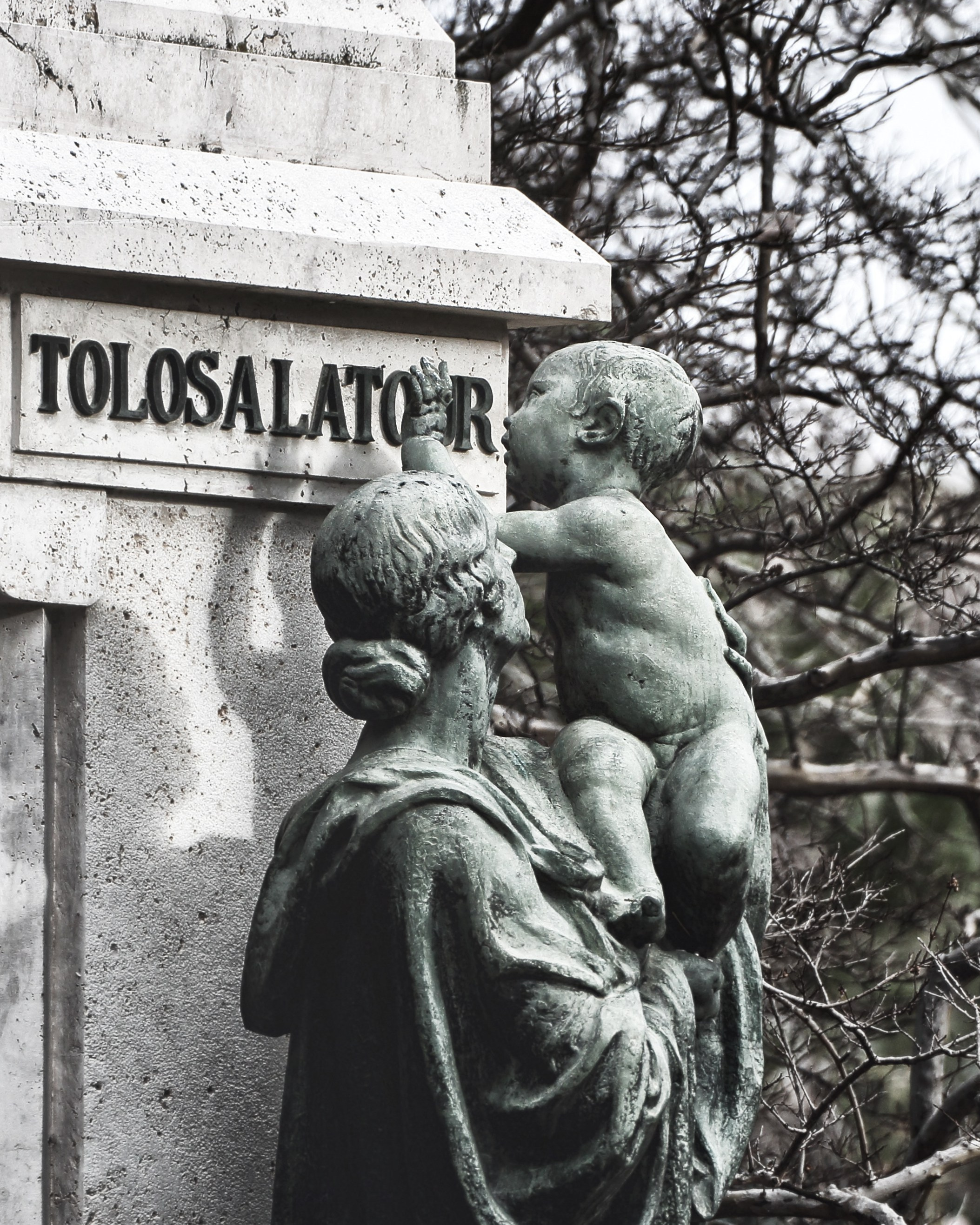 Скульптура женщины с ребенком у памятника с надписью TOLOSALATOR, бронзовая или каменная композиция, кладбищенское искусство