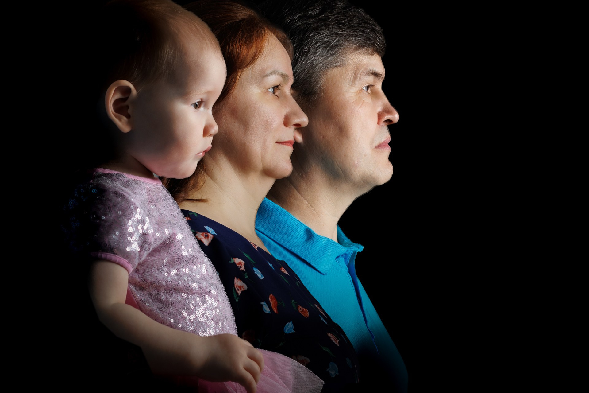 Семейный портрет в профиль на тёмном фоне