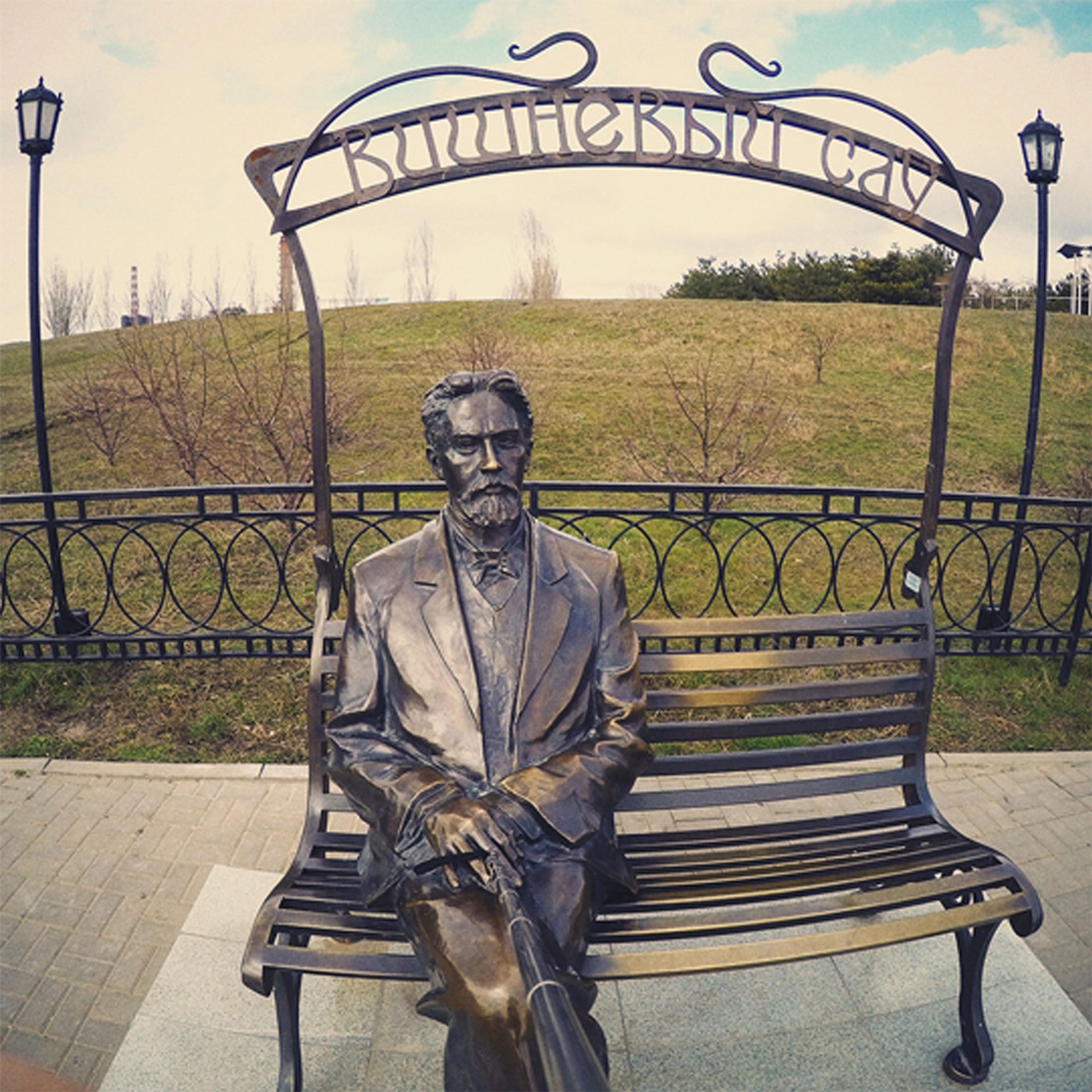 Фотография памятника А.П. Чехова в городе Таганроге. Памятник был установлен в честь выдающегося русского писателя, который родился и провел в Таганроге свои ранние годы. На фото запечатлено изображение памятника, где Чехов изображен сидящим на скамейке в одной из его традиционных поз, в окружении зелени. Памятник является важным культурным объектом региона и привлекает туристов своей исторической значимостью и прекрасным исполнением.