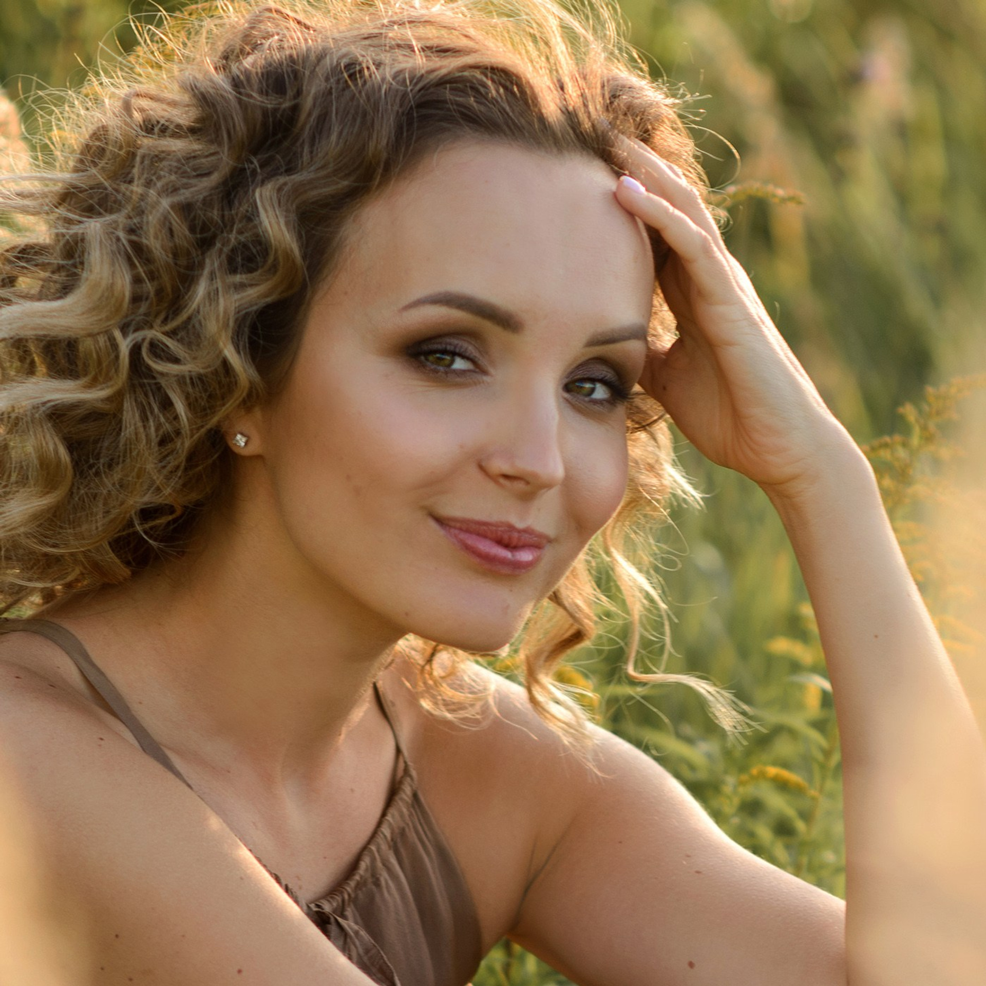 Woman photo shoot in a field in a warm chocolate colors