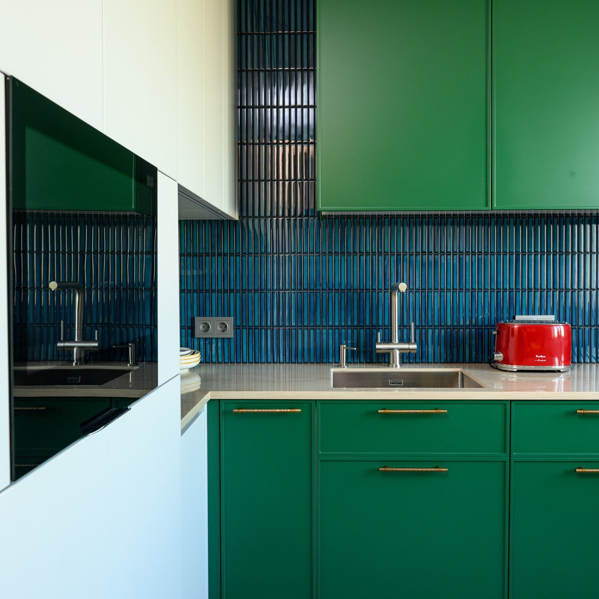 К интегрированной в столешницу мойке подключили стильный смеситель с высоким изливом, который дополнили компаньоном – дозатором моющего средства. 