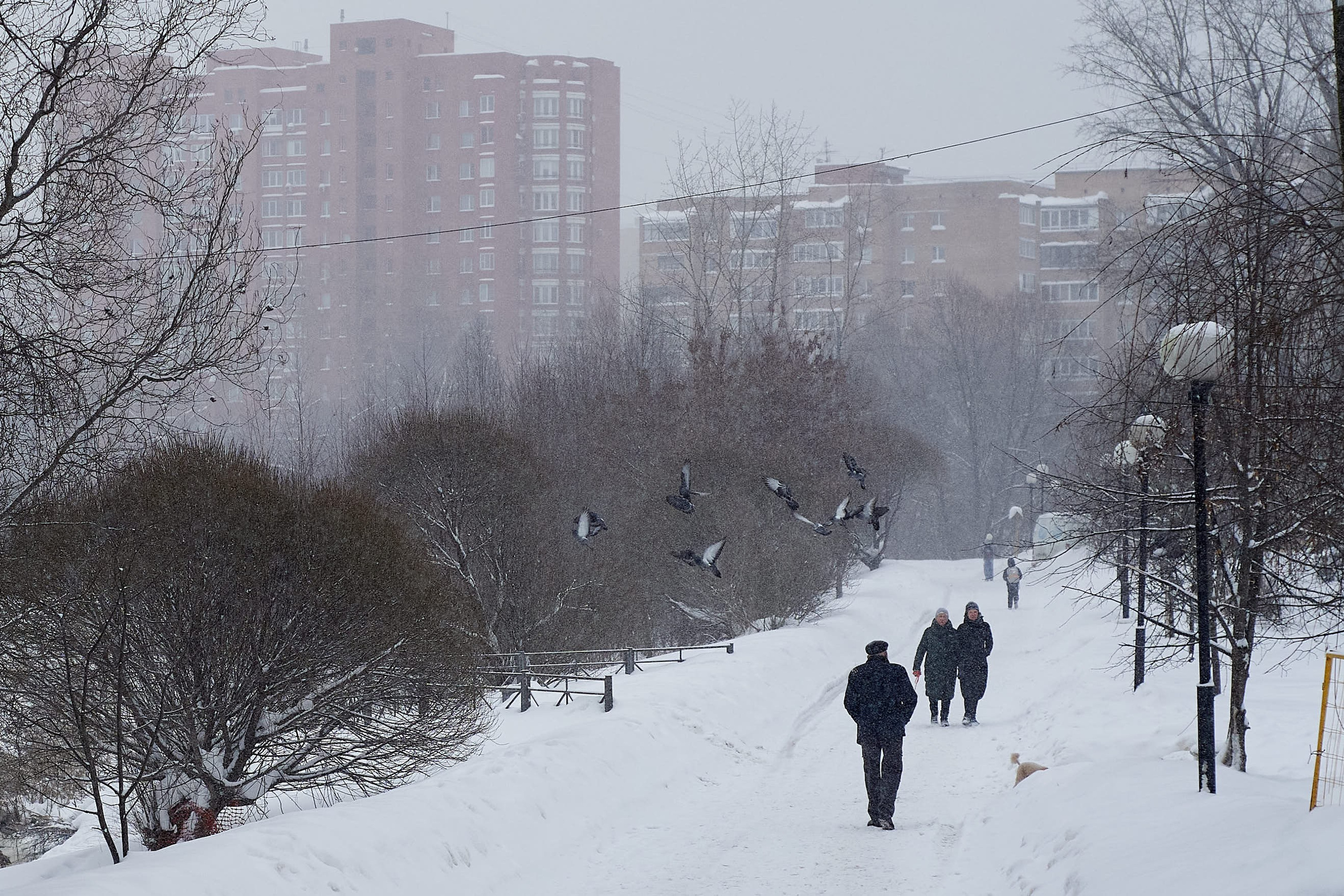 White Russian winter. People walking along a road covered in fresh snow during winter in Russia.