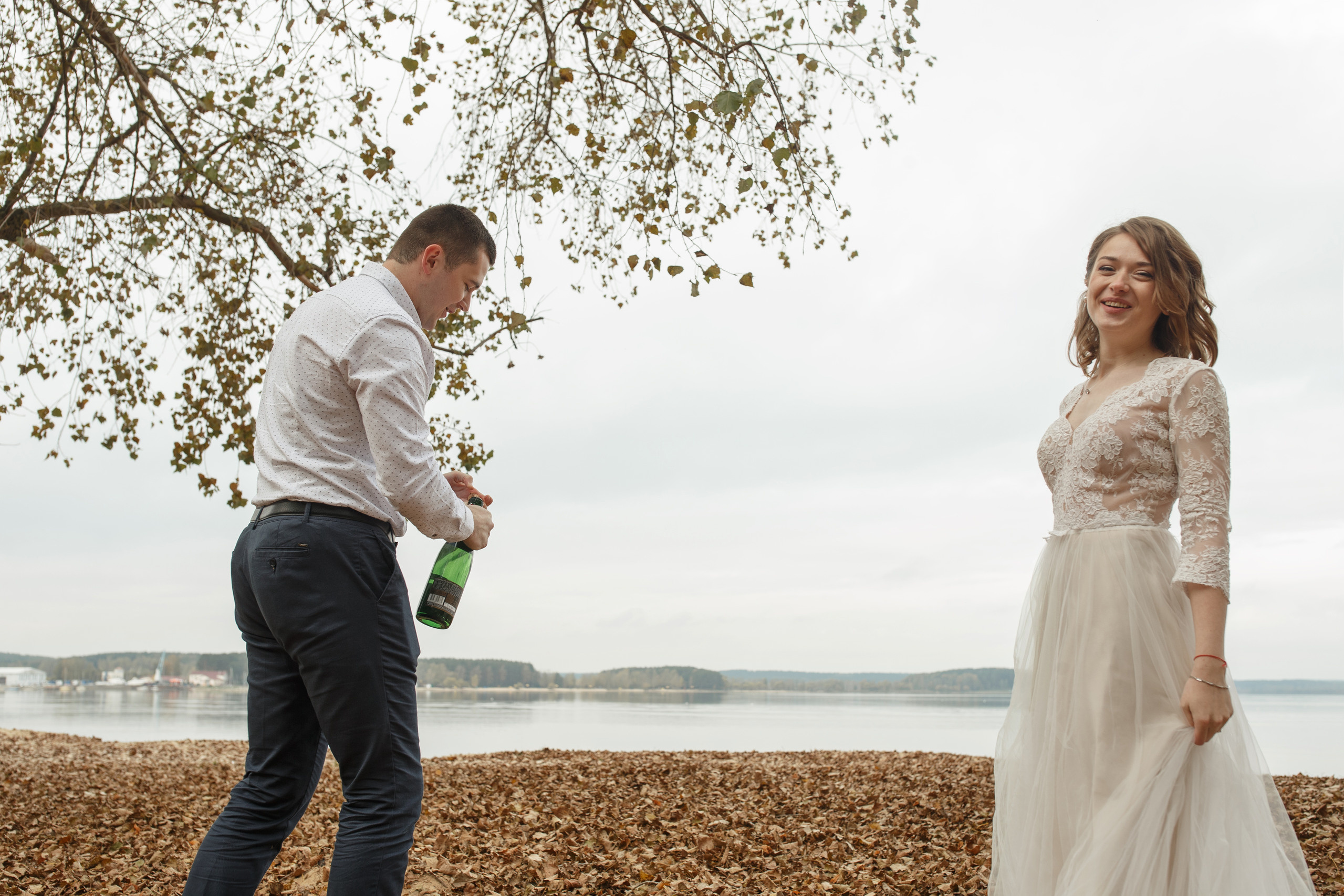 Свадебная прогулка красивой пары на берегу озера