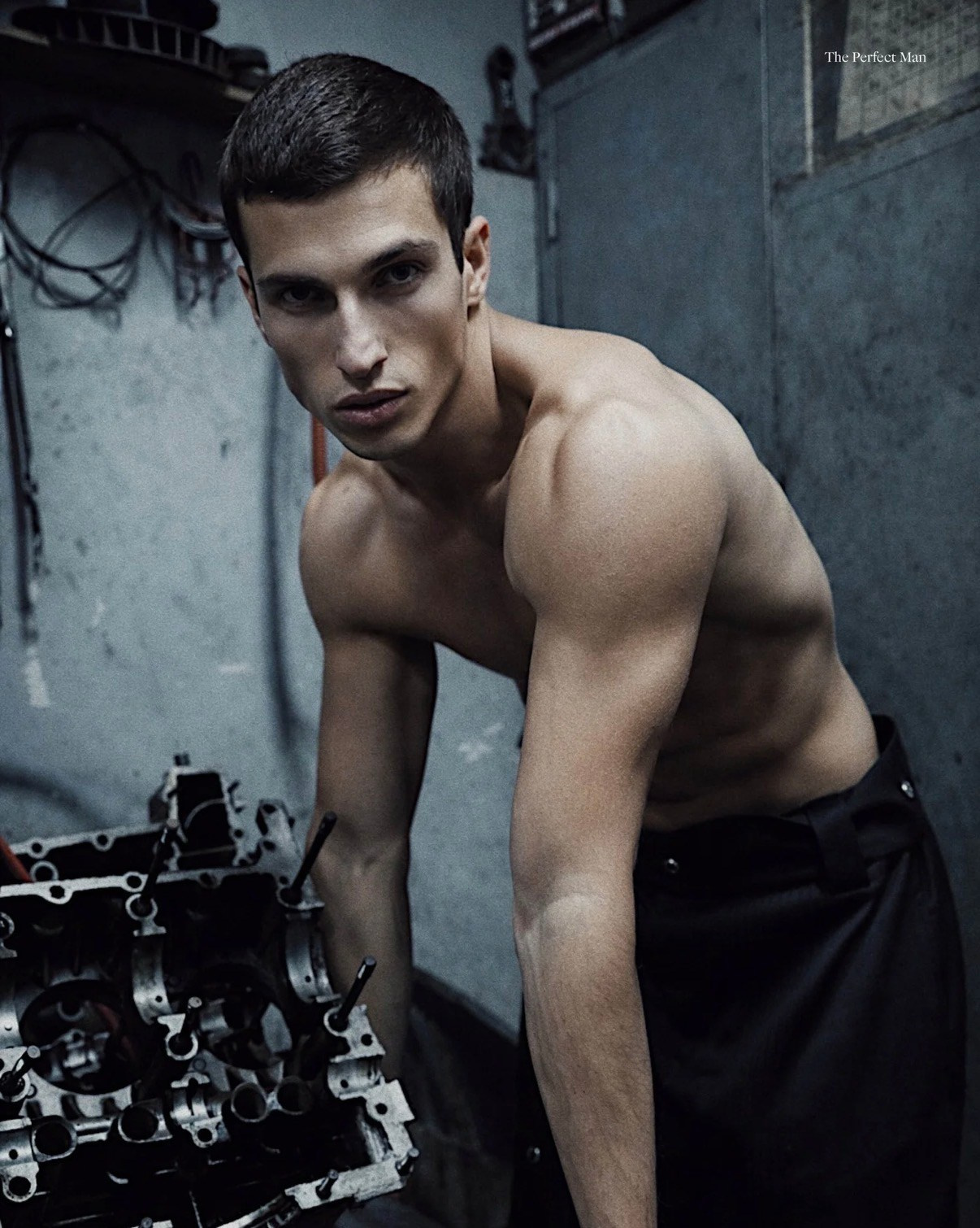 Editorial male fashion portrait in industrial garage location for The Perfect Man Style Magazine
