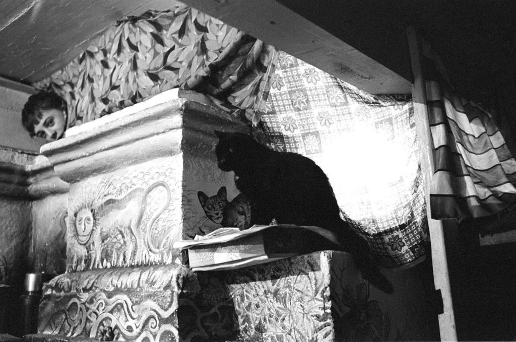 Pashka and the cat are warming themselves on the Russian stove. Autumn 2012.