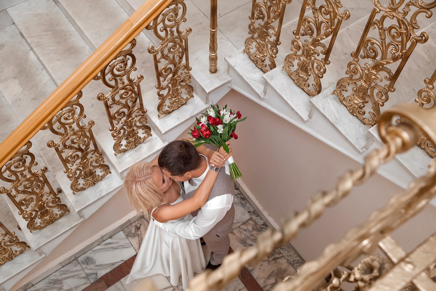 Молодожёны стоят внизу лестницы в ЗАГСе Ульяновск 