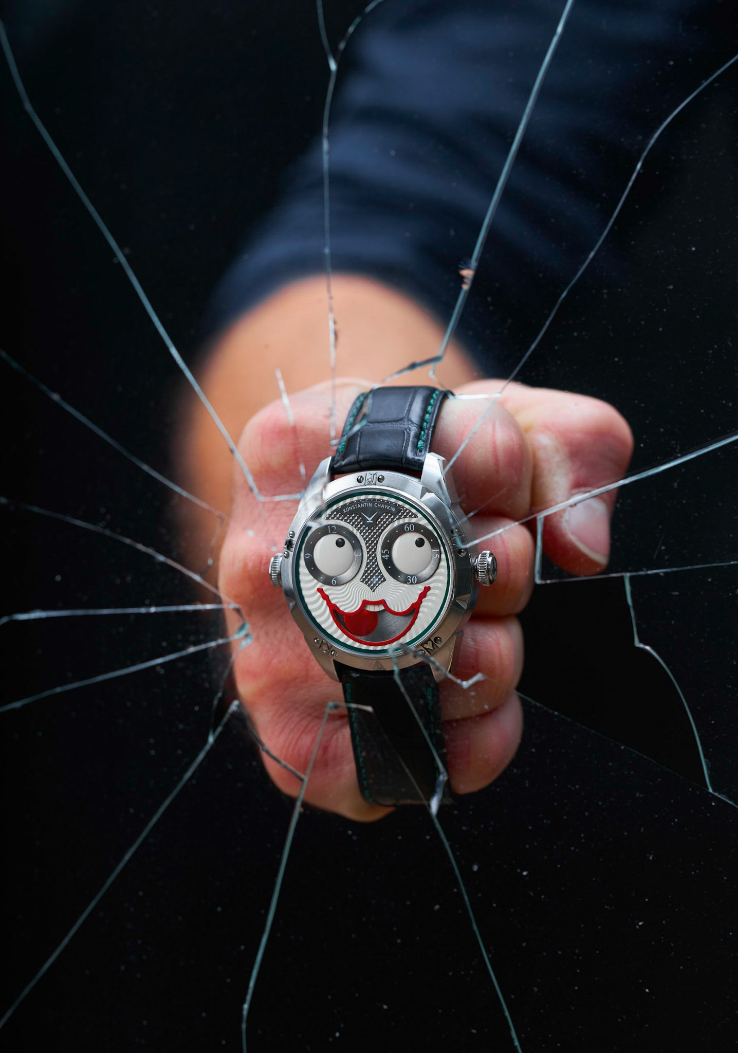 Hand wearing Kontantin Chaykin wristmon Joker watch breaking glass - photographer Andrey Dunin