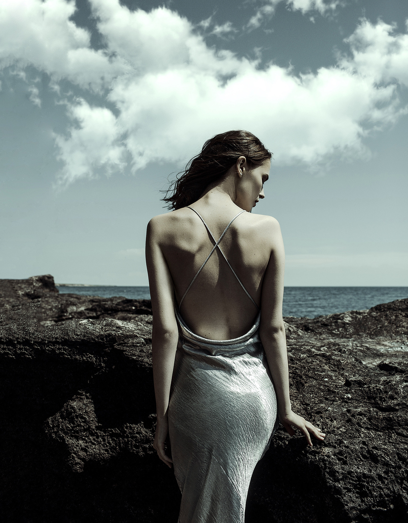 Fashion photo session on the coast of the rocky sea Crimea, Spain, Malta